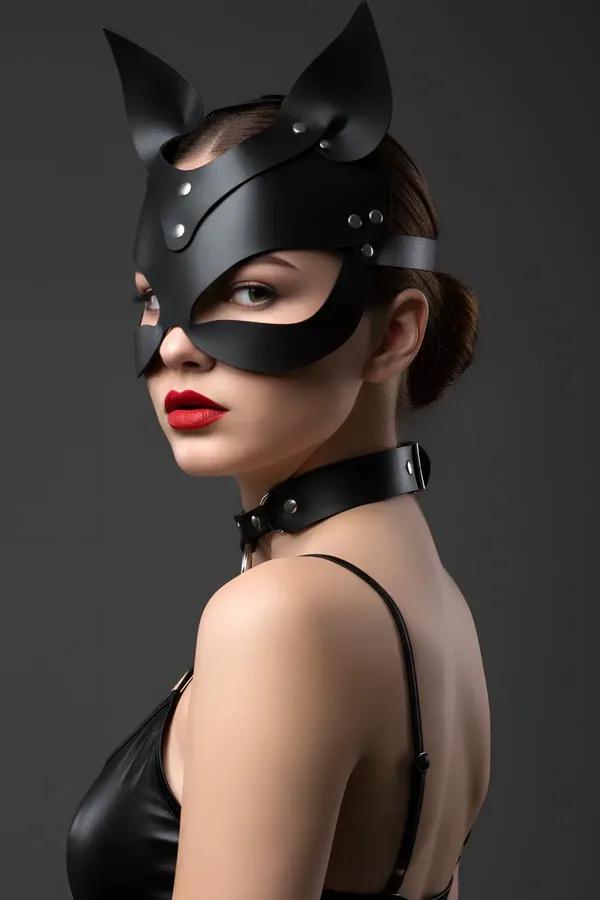 black faux leather cat mask with stand-up ears and silver studs worn with matching O-ring choker