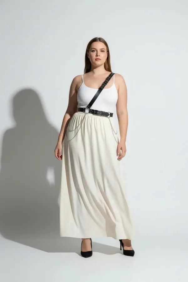 black faux leather single shoulder harness belt with silver chains and o-ring worn over white tank top