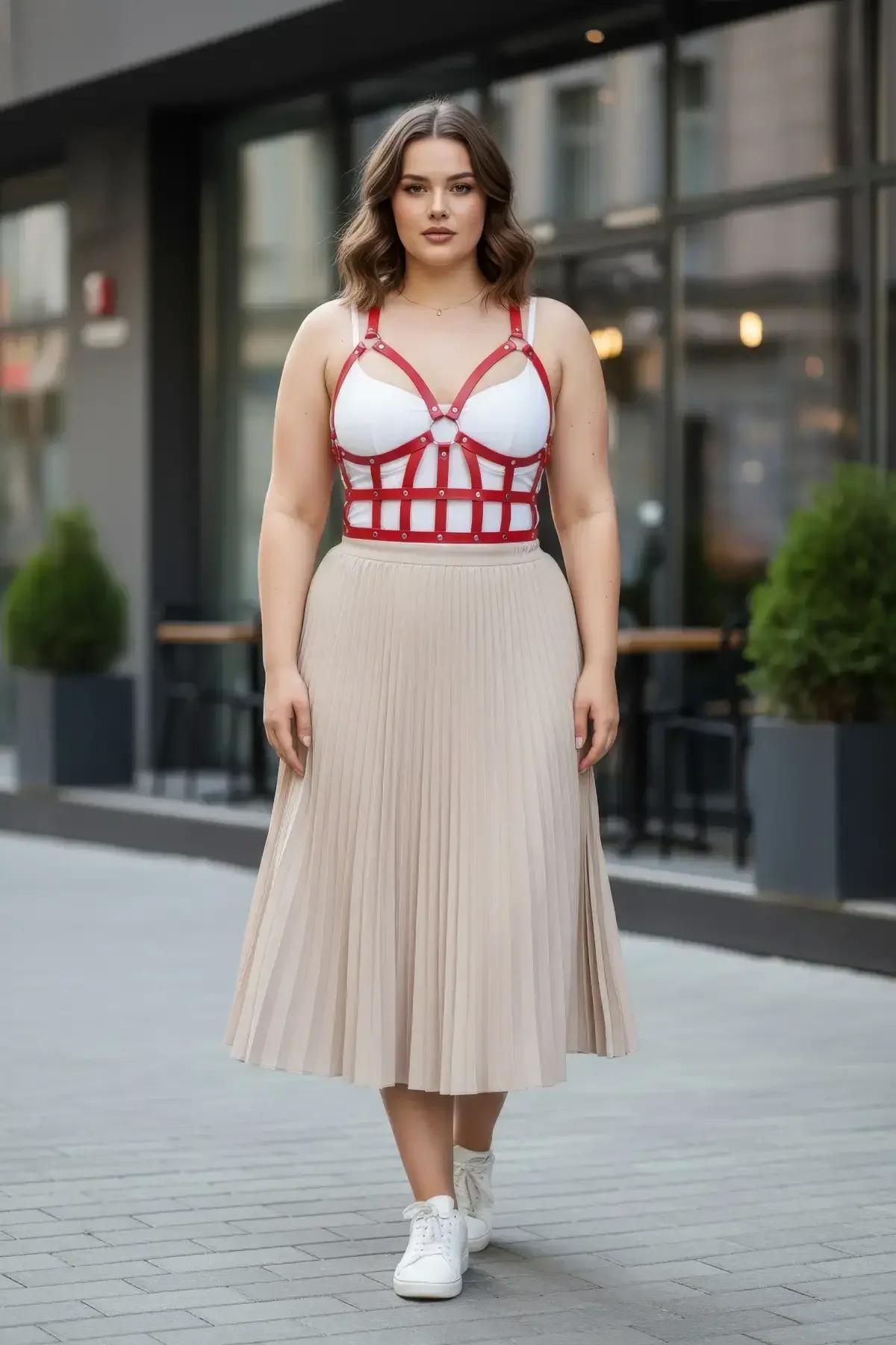 red faux leather caged bustier harness with grid strap pattern O-ring detail and silver rivets worn over white bra