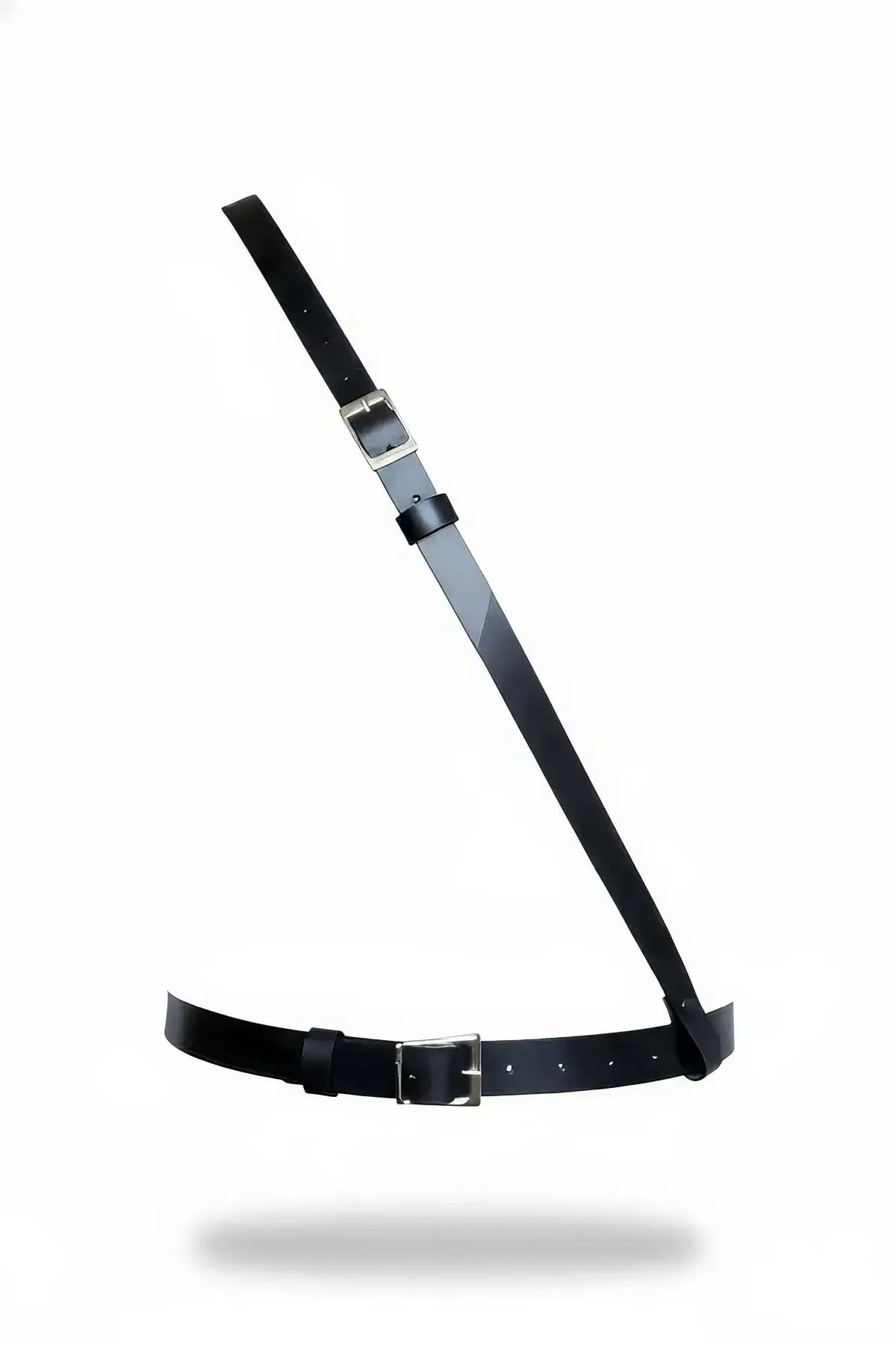 black faux leather single shoulder body harness with diagonal strap and silver square buckles on white background