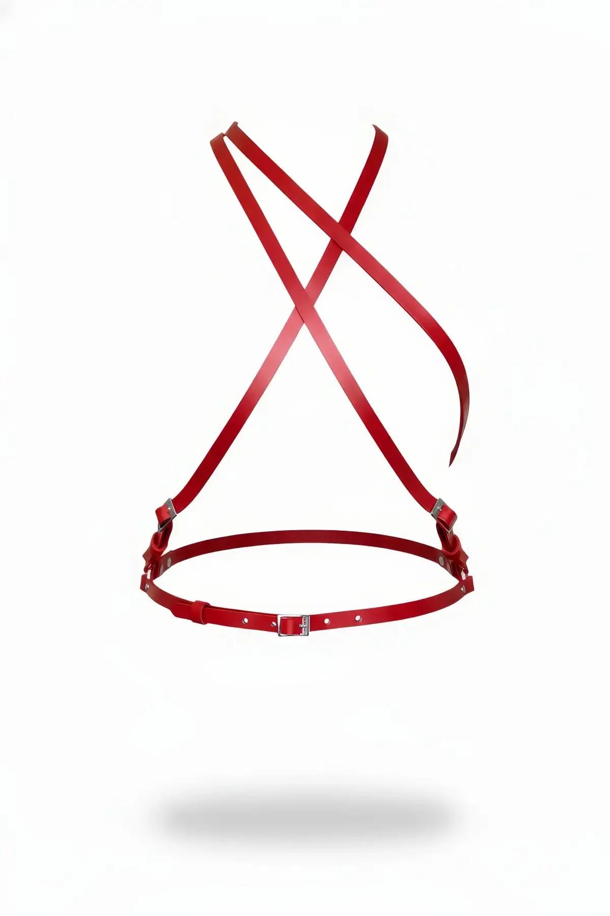 red faux leather chest harness with X-back crossing straps and silver side buckles on white background