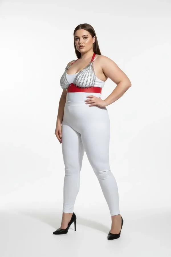 red faux leather chest harness with silver chain straps worn by plus-size model over white high-waist leggings
