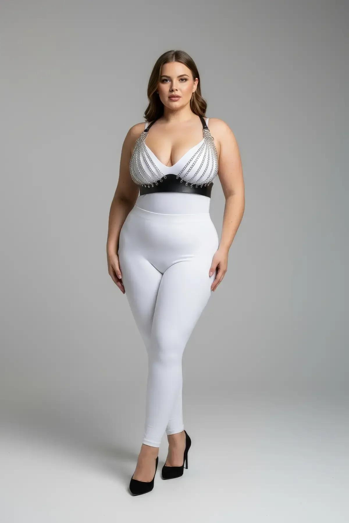 white faux leather harness bra with layered silver chain rows across cups and black underbust band, plus-size model