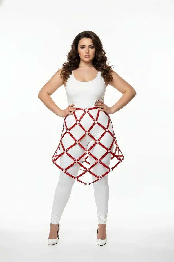 red faux leather lattice cage skirt harness with silver O-ring connectors worn over white leggings, A-line diamond grid silho