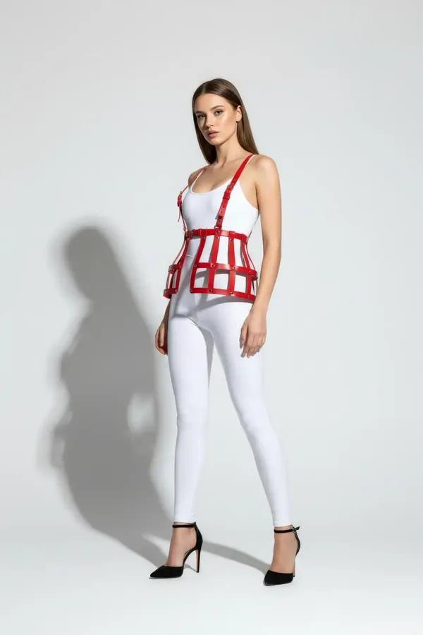 red faux leather cage waist harness with silver rivets and adjustable shoulder straps worn over white bodysuit