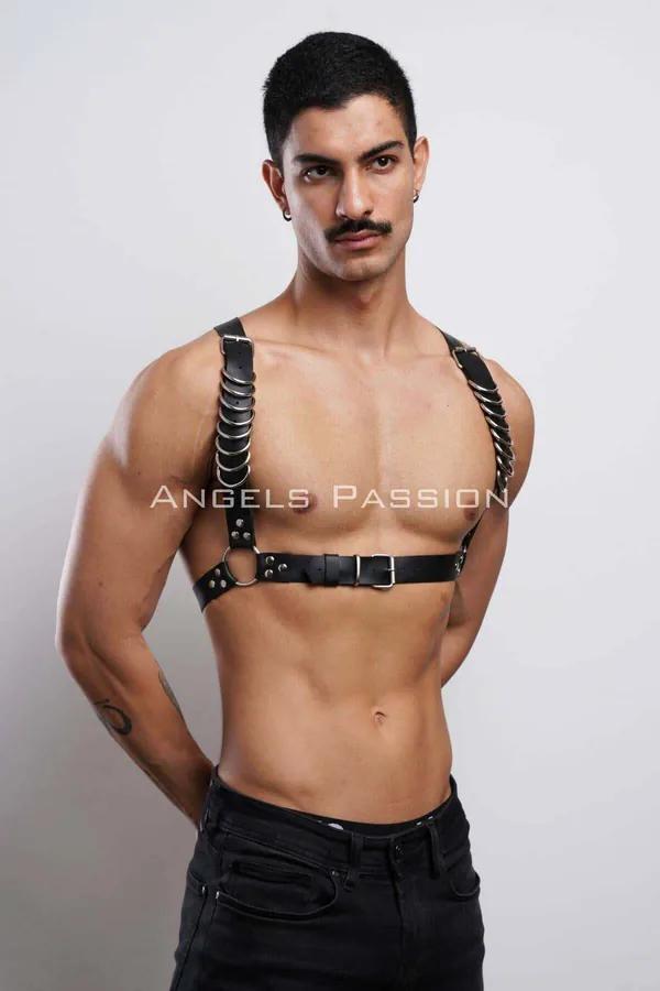Black faux leather chest harness with cascading silver O-ring chain on shoulder strap worn by male model
